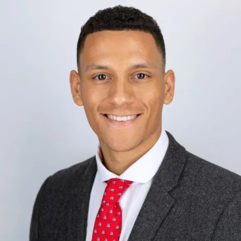 Head and shoulders picture of Khavan Bryan, smiling and smartly dressed