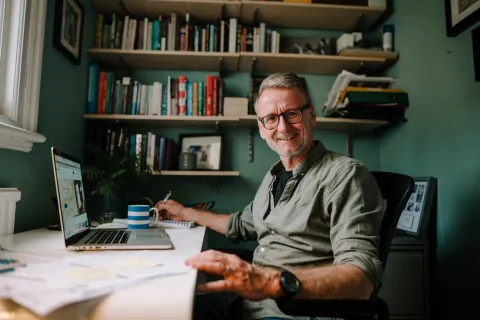 Older man working from home on a laptop 