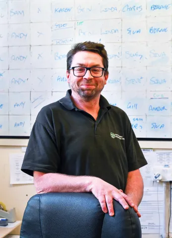 A man standing in front of a white board