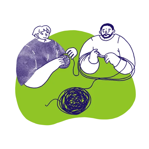 Two people unwinding a ball of yarn