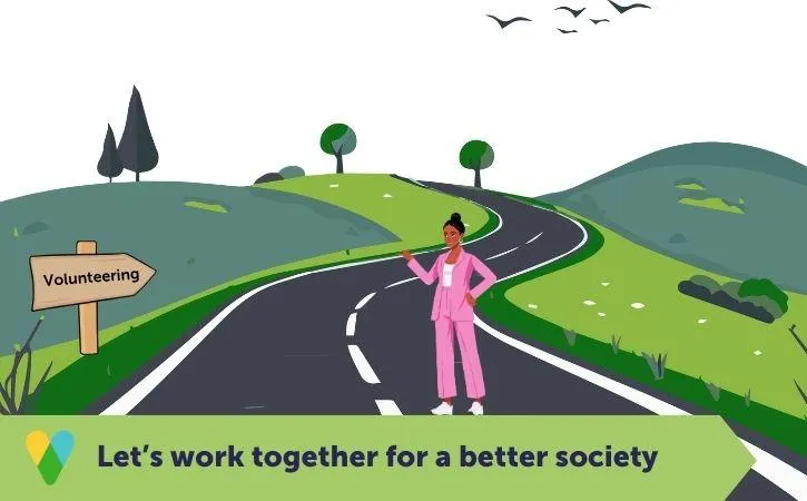 Image of a person standing on a road next to a signpost that reads 'Volunteering'