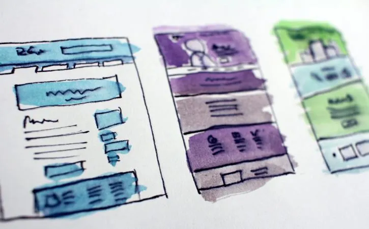 image shows a water colour drawing of 3 buildings, one in blue, one purple and one green.