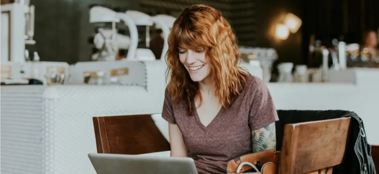Woman working at desk in cafe