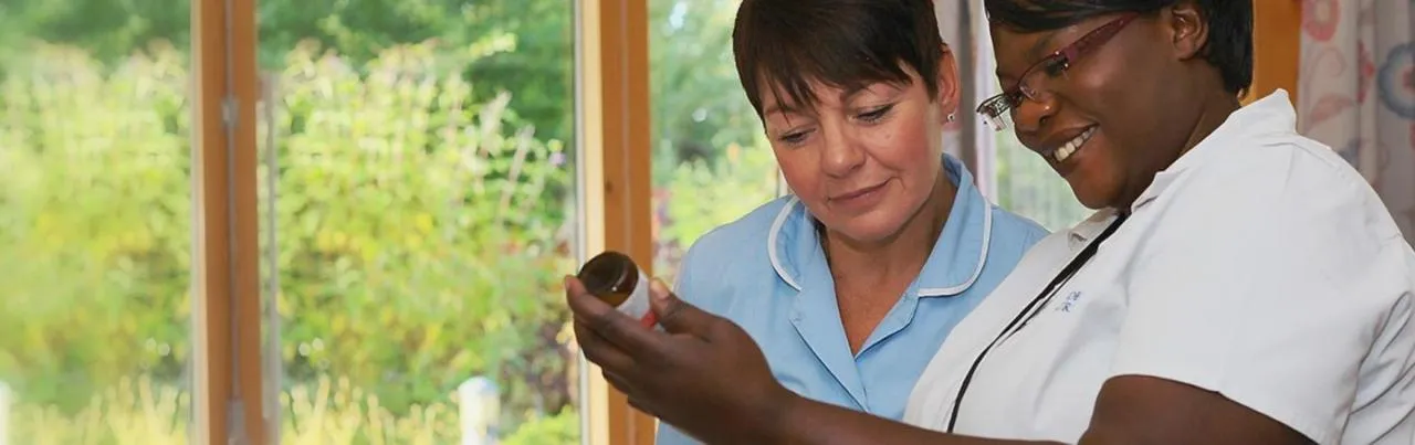 Two nurses discussing medication