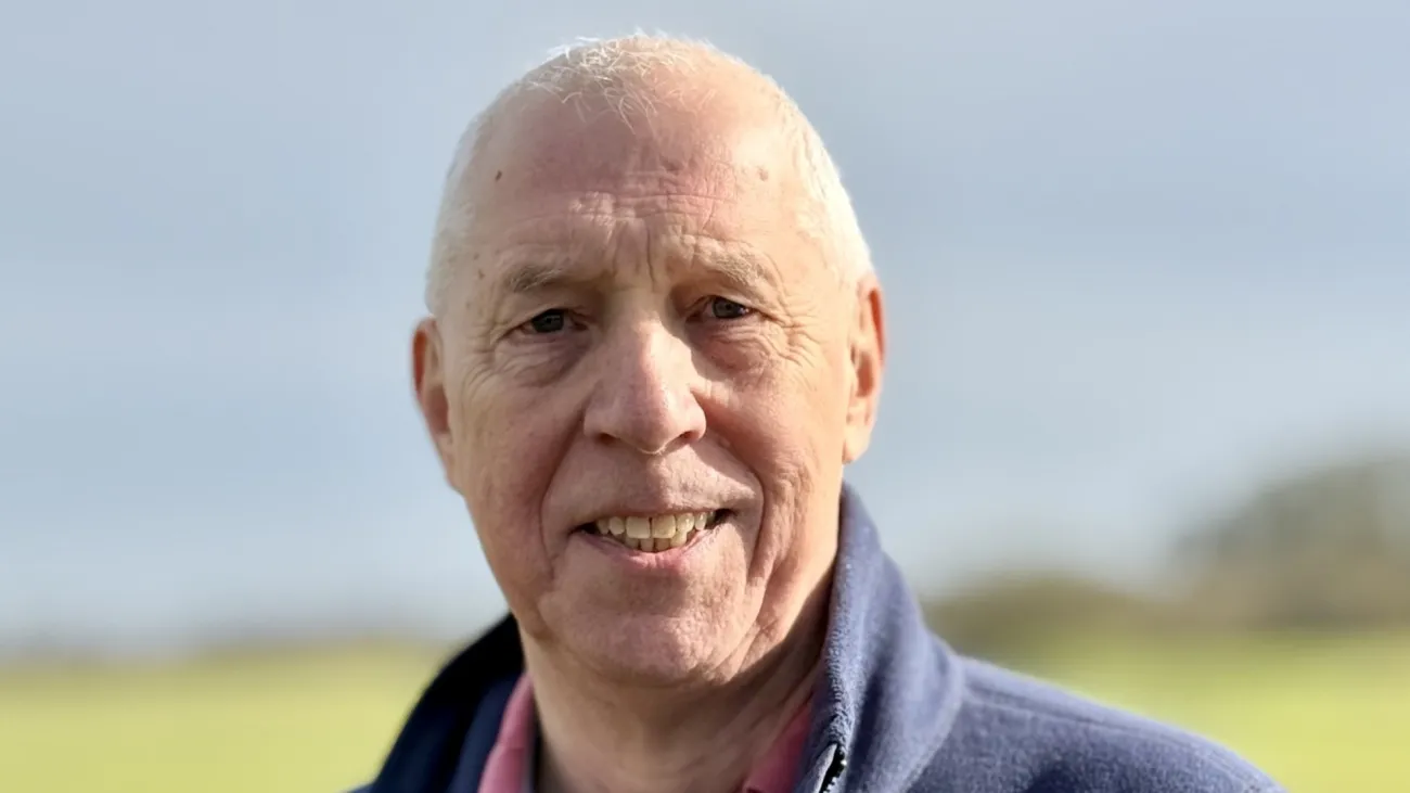 A picture of a smiling man in a dark blue fleece