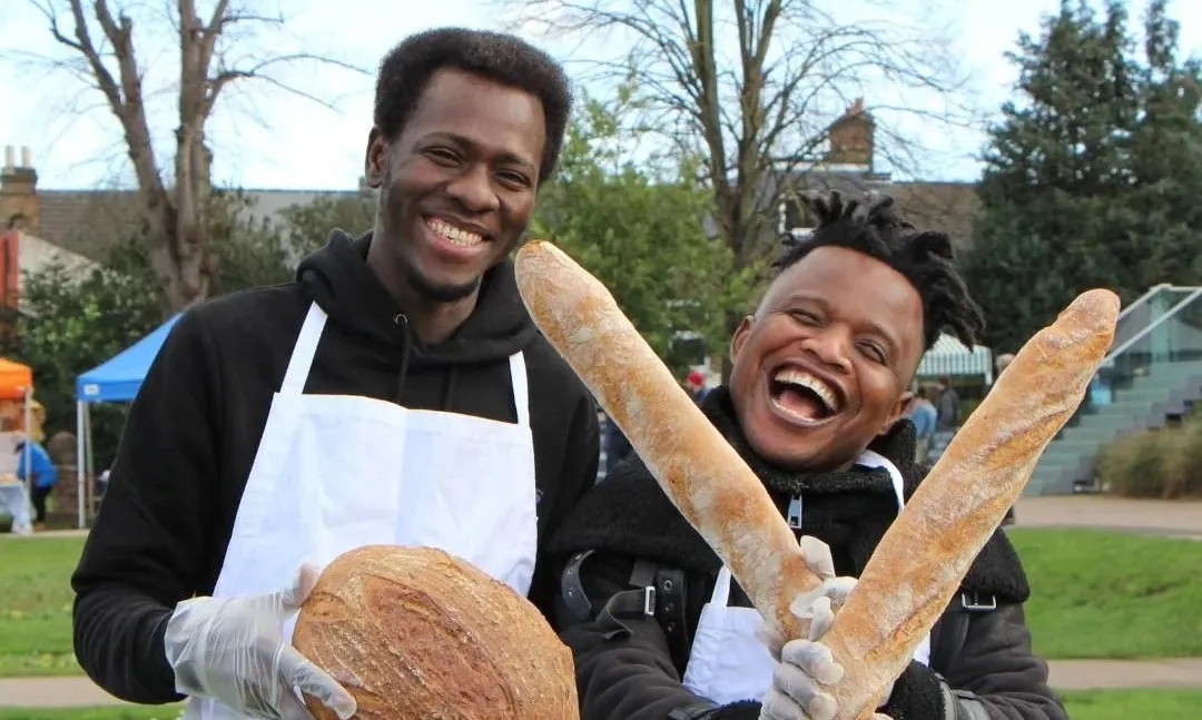 Two young refugees smiling at an event