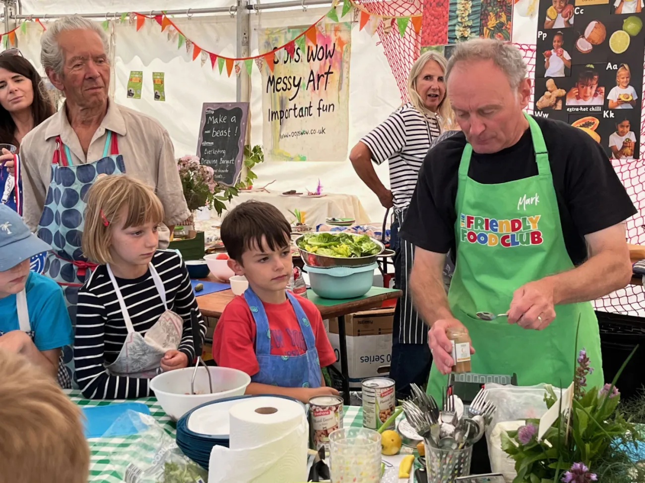 A group of people watching a cookery workshop