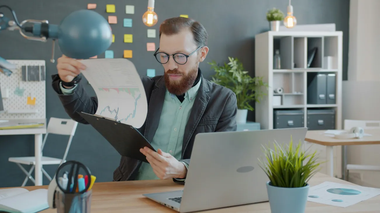 Man pouring over financial charts