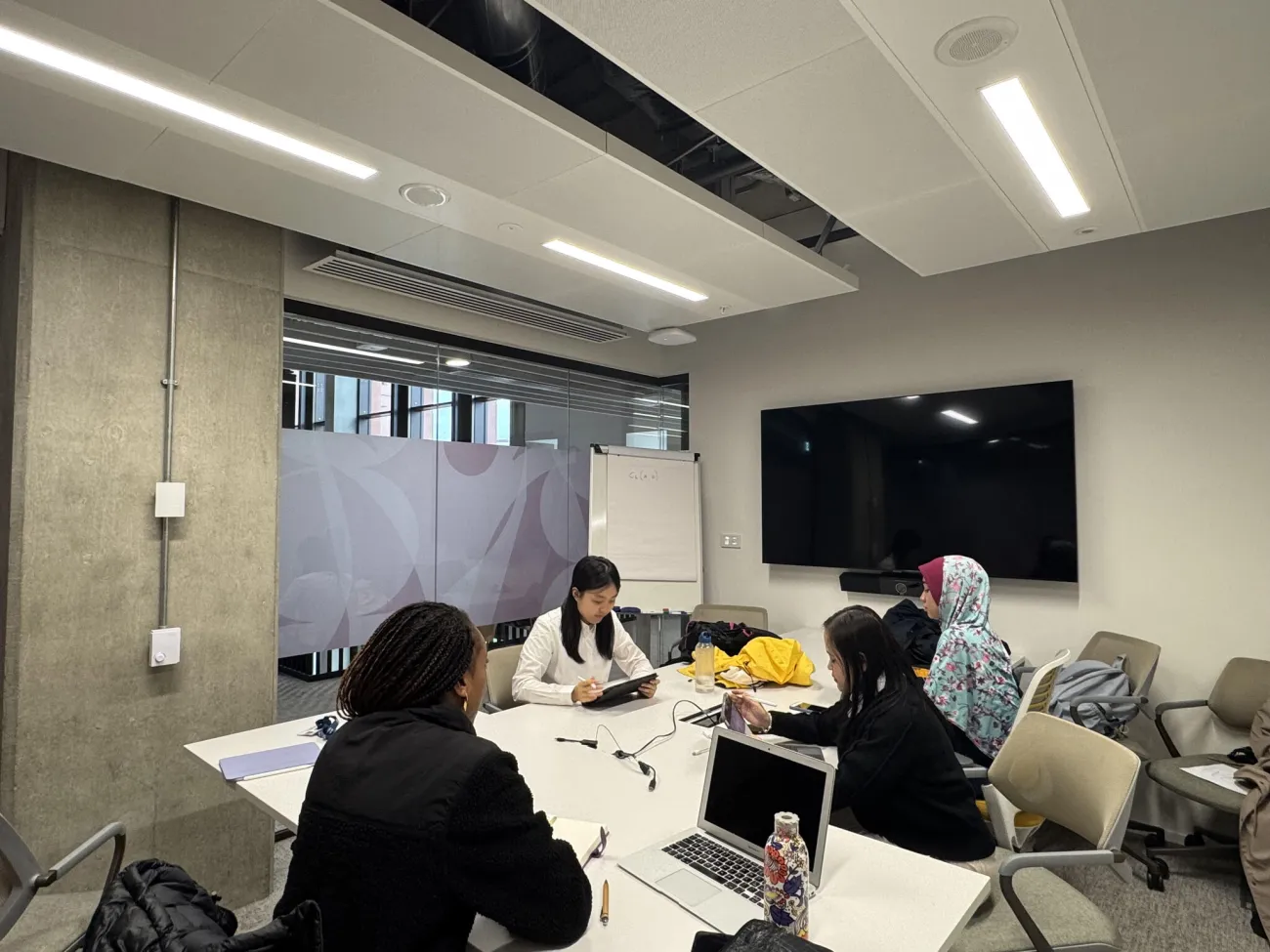Some of the Migrant Women Press team in a meeting room. 