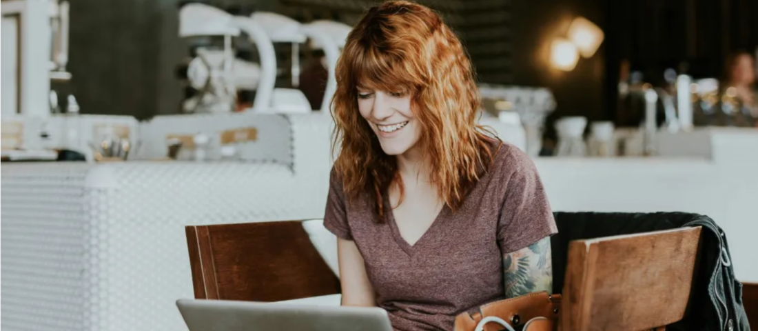Woman working at desk in cafe