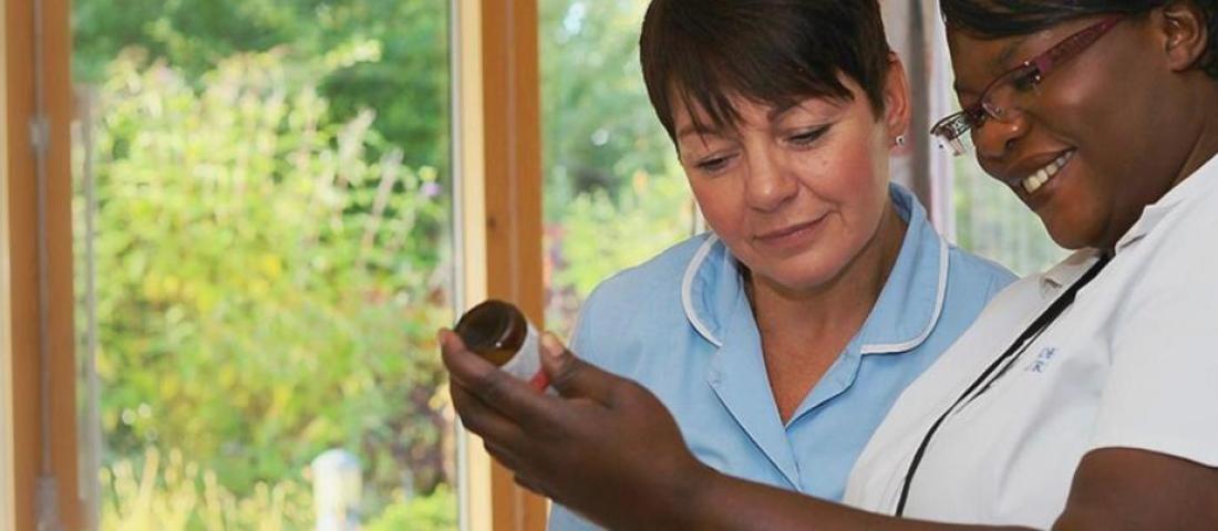 Two nurses discussing medication