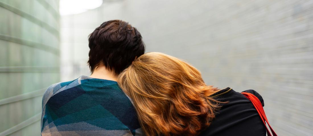 Women leaning on another woman's shoulder