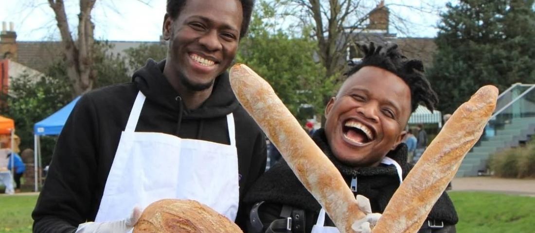 Two young refugees smiling at an event