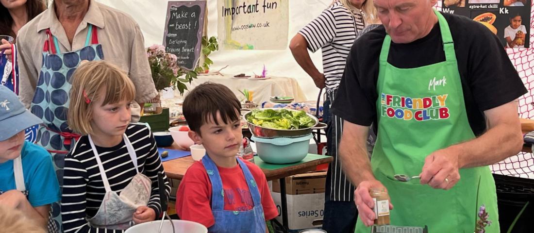 A group of people watching a cookery workshop
