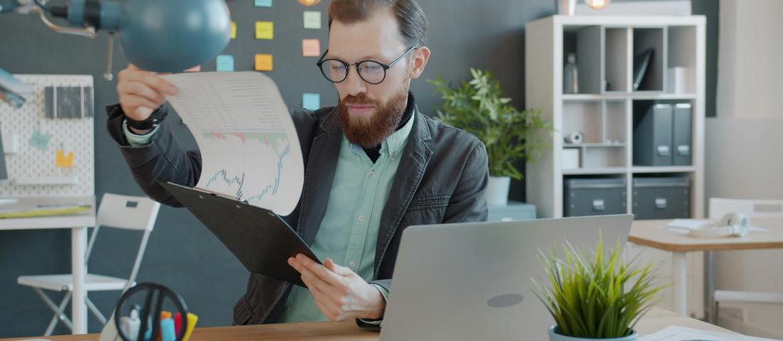 Man pouring over financial charts