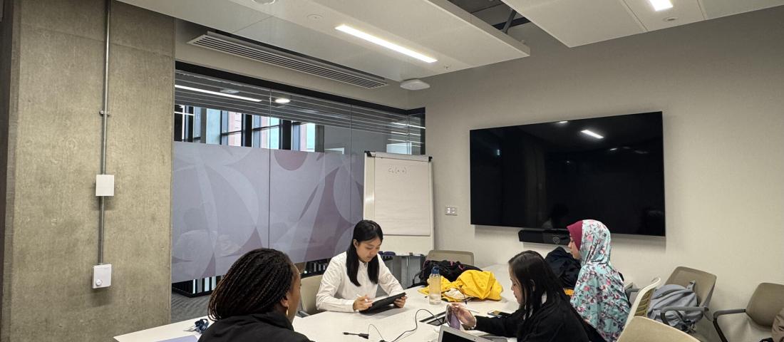 Some of the Migrant Women Press team in a meeting room. 
