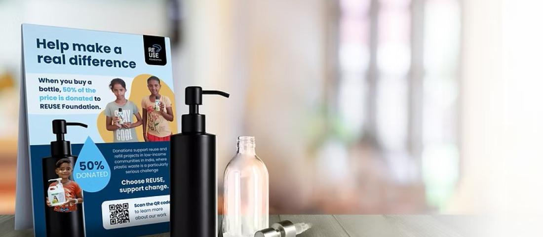 Refillable plastic bottles near a leaflet promoting the Reuse Foundation